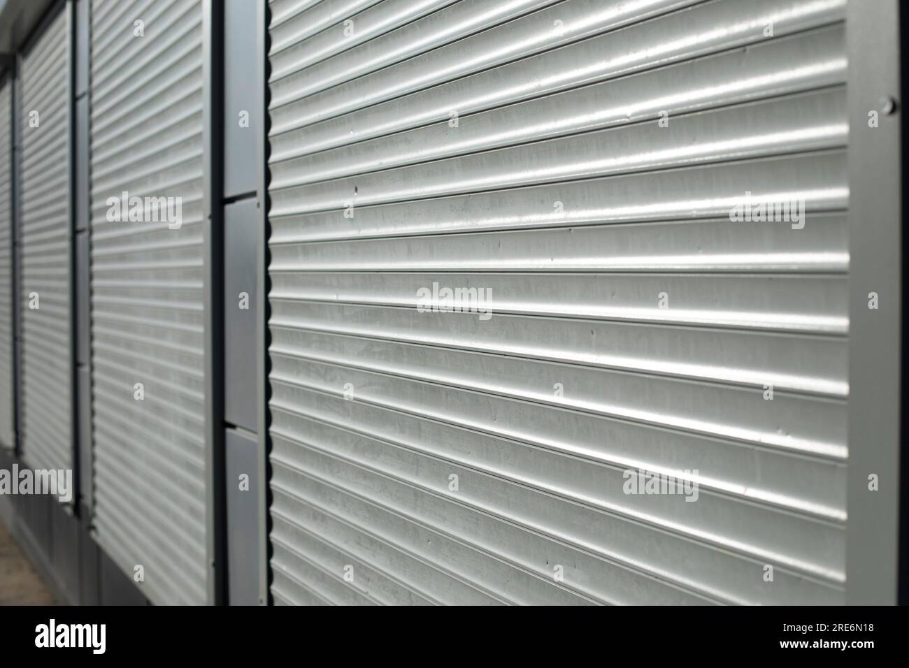 Blinds on window. Plastic shutters. Ribbed surface. Closed windows