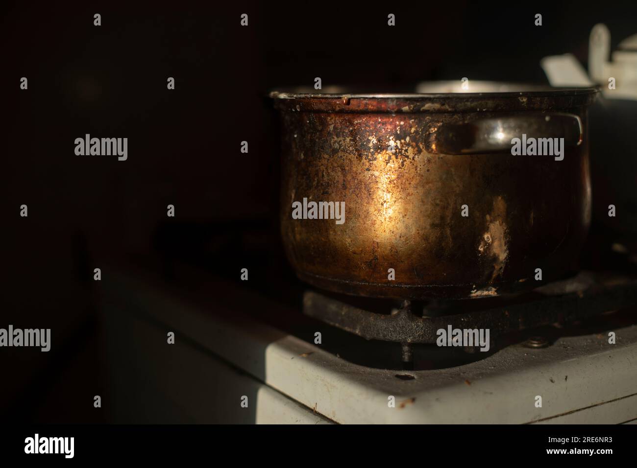Rusty pot in kitchen. Old dishes. Kitchen details. Light on metal Stock