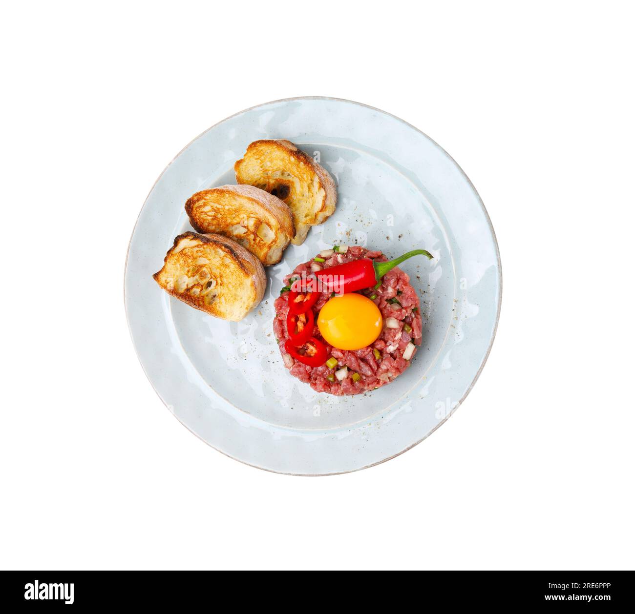 Tasty beef steak tartare served with yolk, toasted bread and other