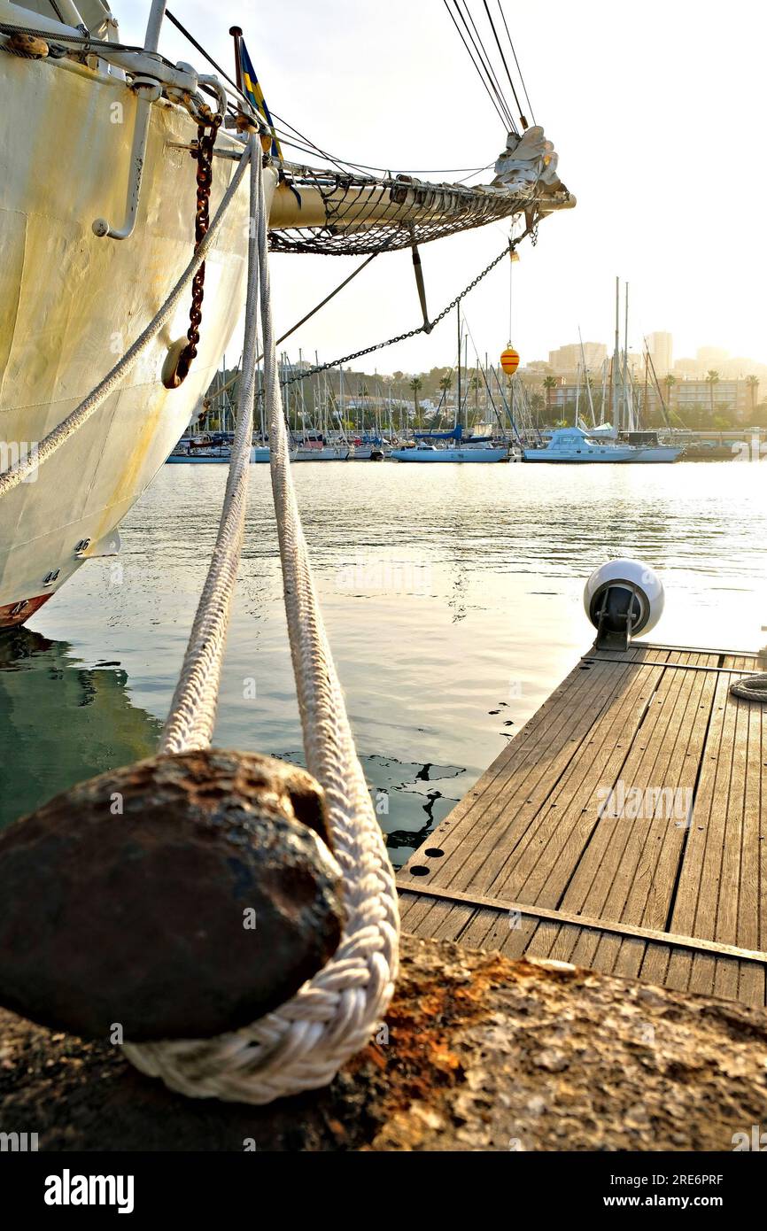 Classic sailing ship docked in a harbor, bollard, heavy mooring line
