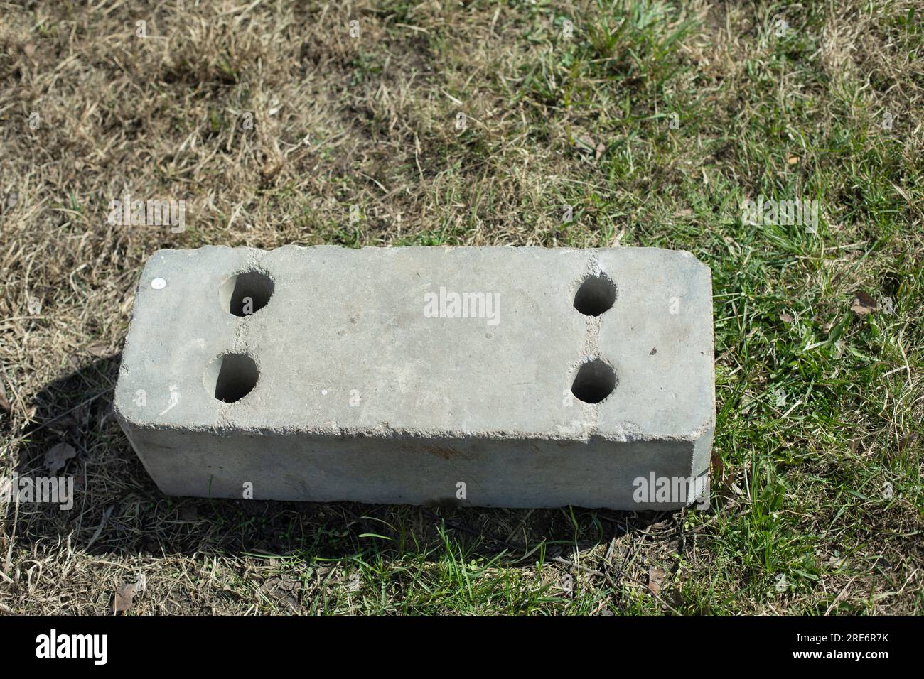 Concrete blocks lie on grass. Construction debris in park. Concrete