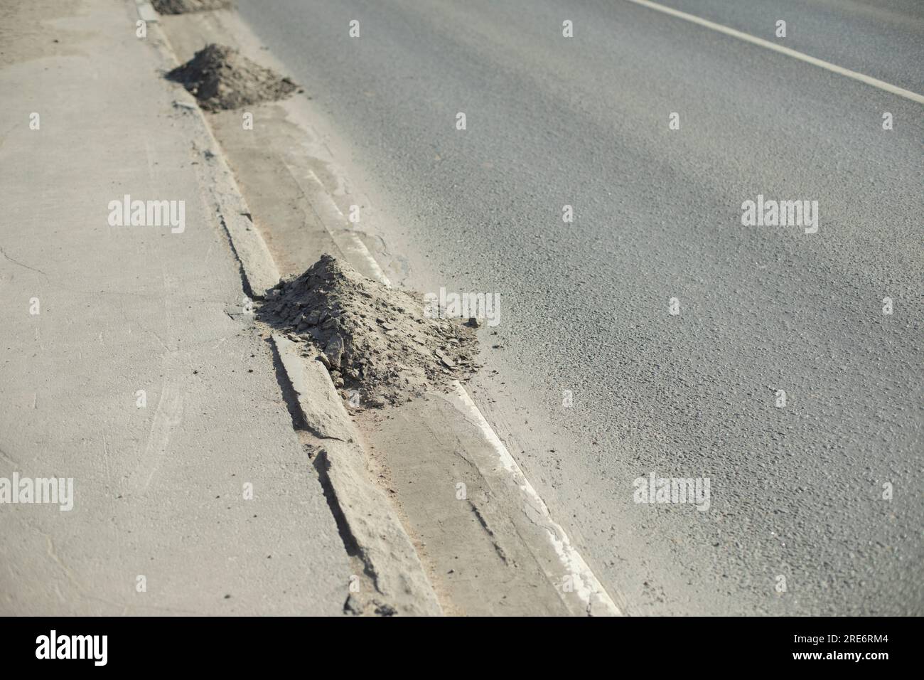 Dirt on road. Dust at curb. Asphalt cleaning. Swept away garbage Stock