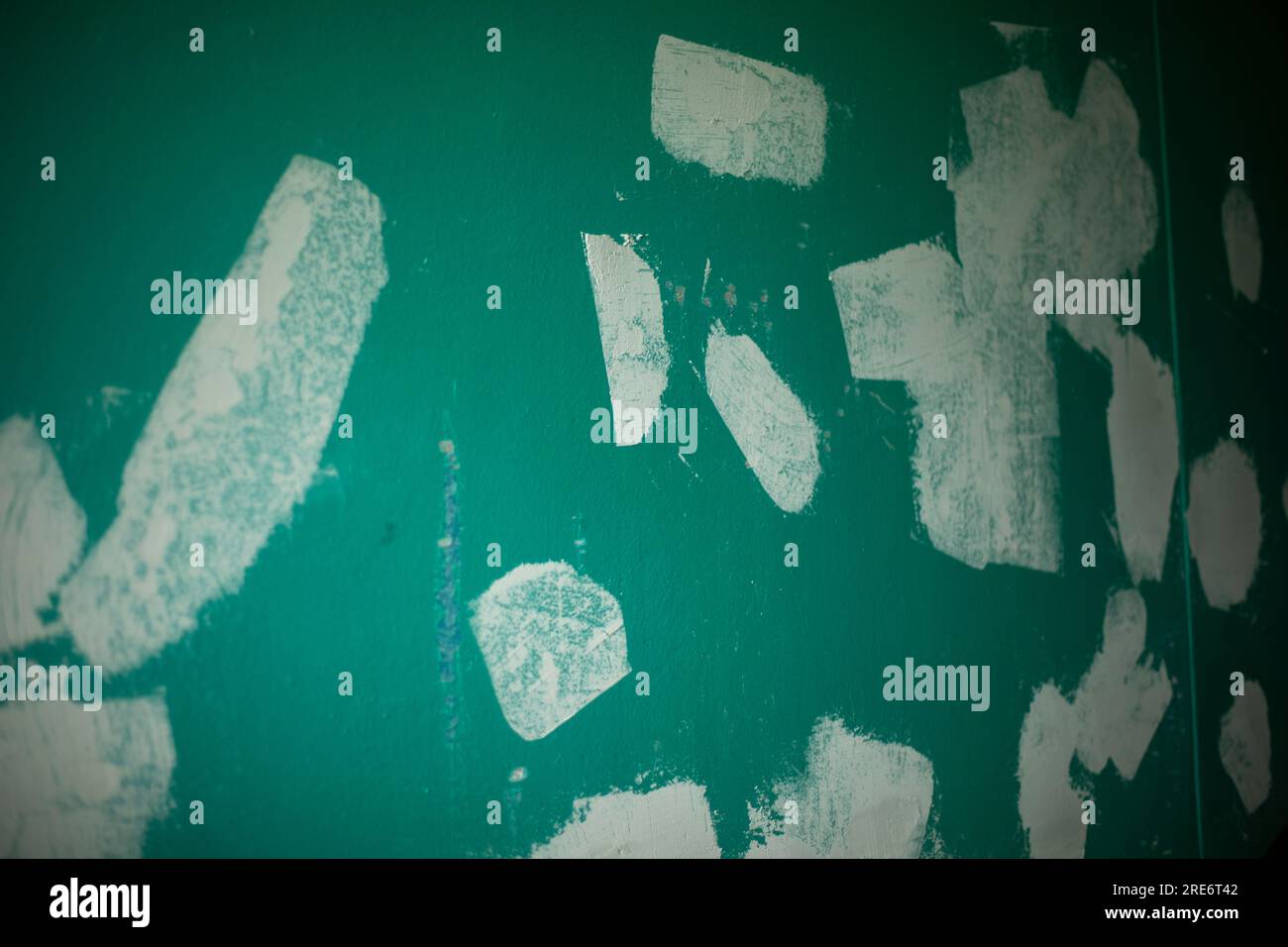 Repairing wall. Paint on wall. Surface Finishing Details. White spots on green background Stock