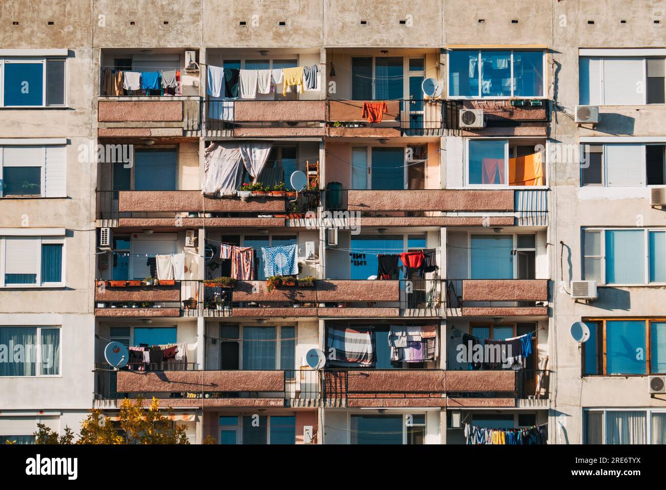clothing hanging to dry on the balconies of Brutalist style apartments in outer Plovdiv, Bulgaria Stock Photo
