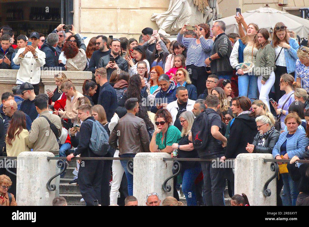 Large crowds of tourists swollen by Italians enjoying a four day Bank Holiday, gather to view the Trevi fountain despite overcast weather, April 2023. Stock Photo