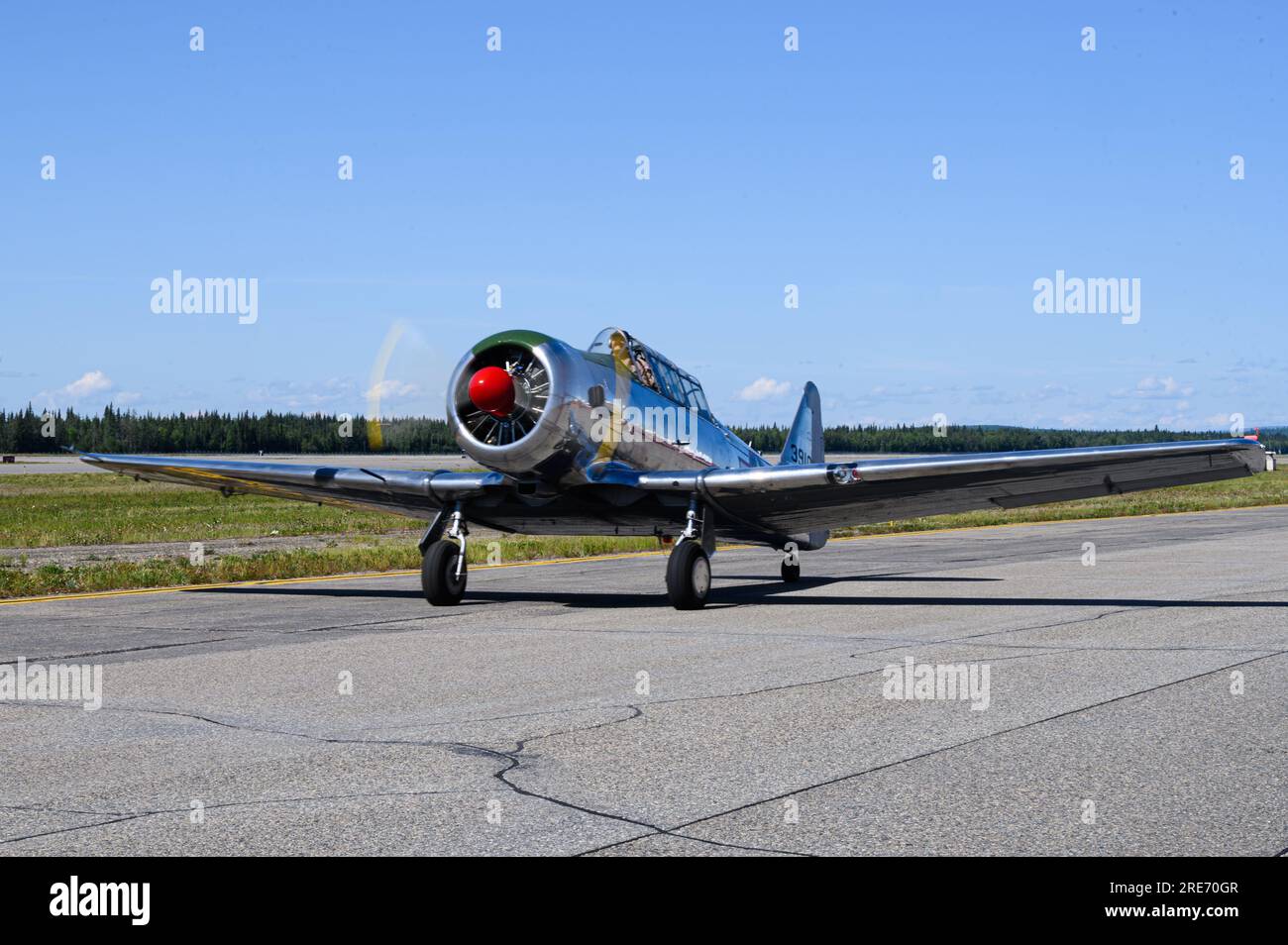 A North American T-6 Texan taxis on the flightline after an aerial performance at the 2023 Arctic Lightning Airshow on Eielson AFB, Alaska, July 21, 2023. The 2023 Arctic Lightning Airshow included aerial and ground performances celebrating the 50-year anniversary of women in military airpower. (U.S. Air Force photo by Senior Airman Jose Miguel T. Tamondong) Stock Photo