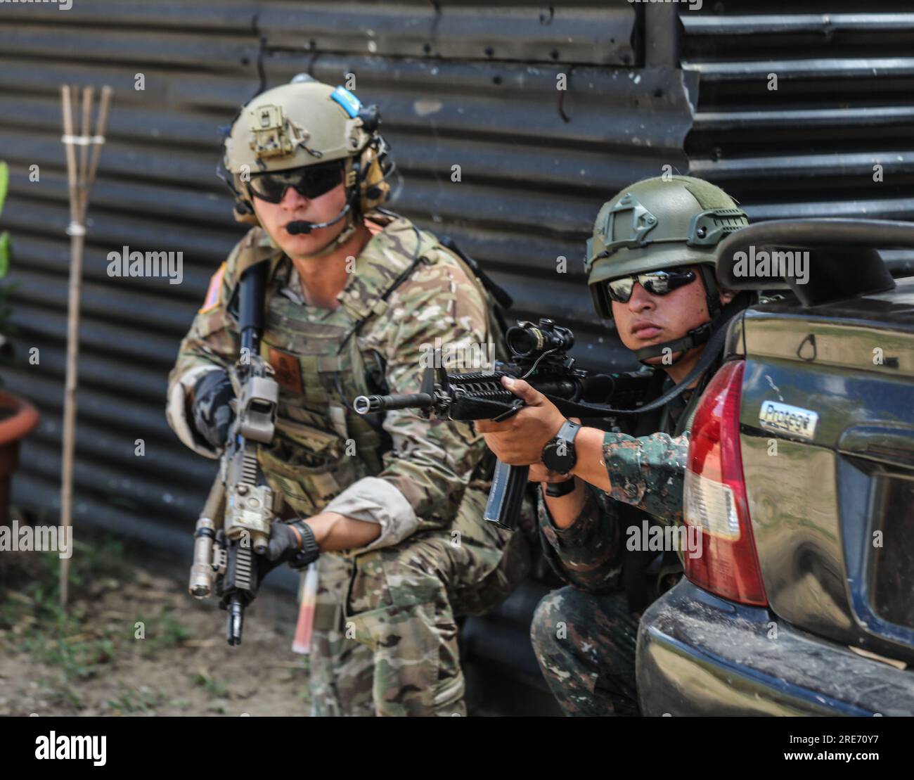 Green beret from 7th Special Forces Group (Airborne) and Guatemalan soldier  pull security at an objective location for the full Mission Profile, during  CENTAM Guardian 23 in El Cerinal, Guatemala on March