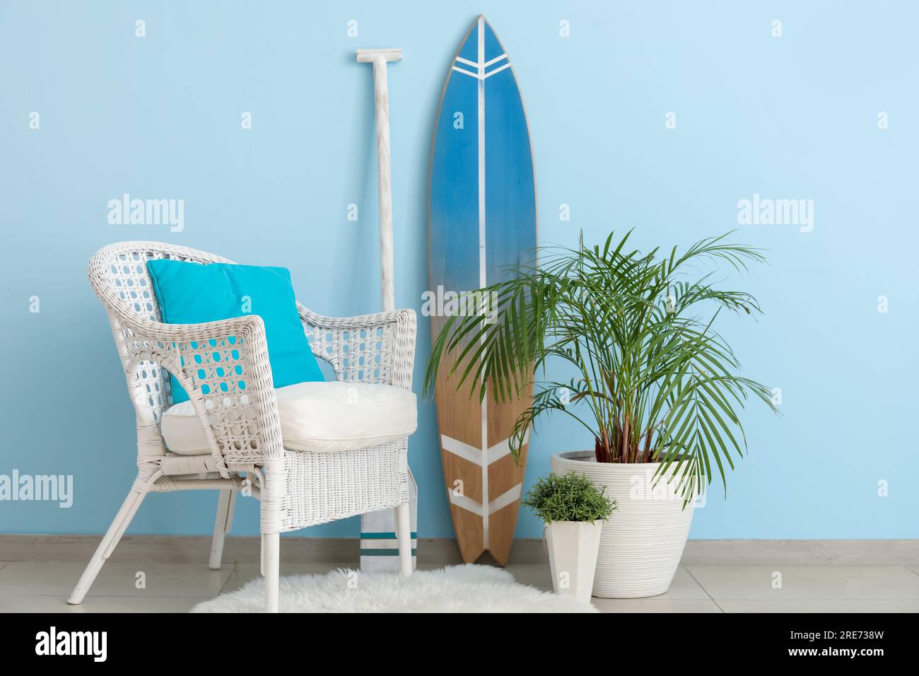 Interior of living room with surfboard, paddle and armchair Stock Photo ...