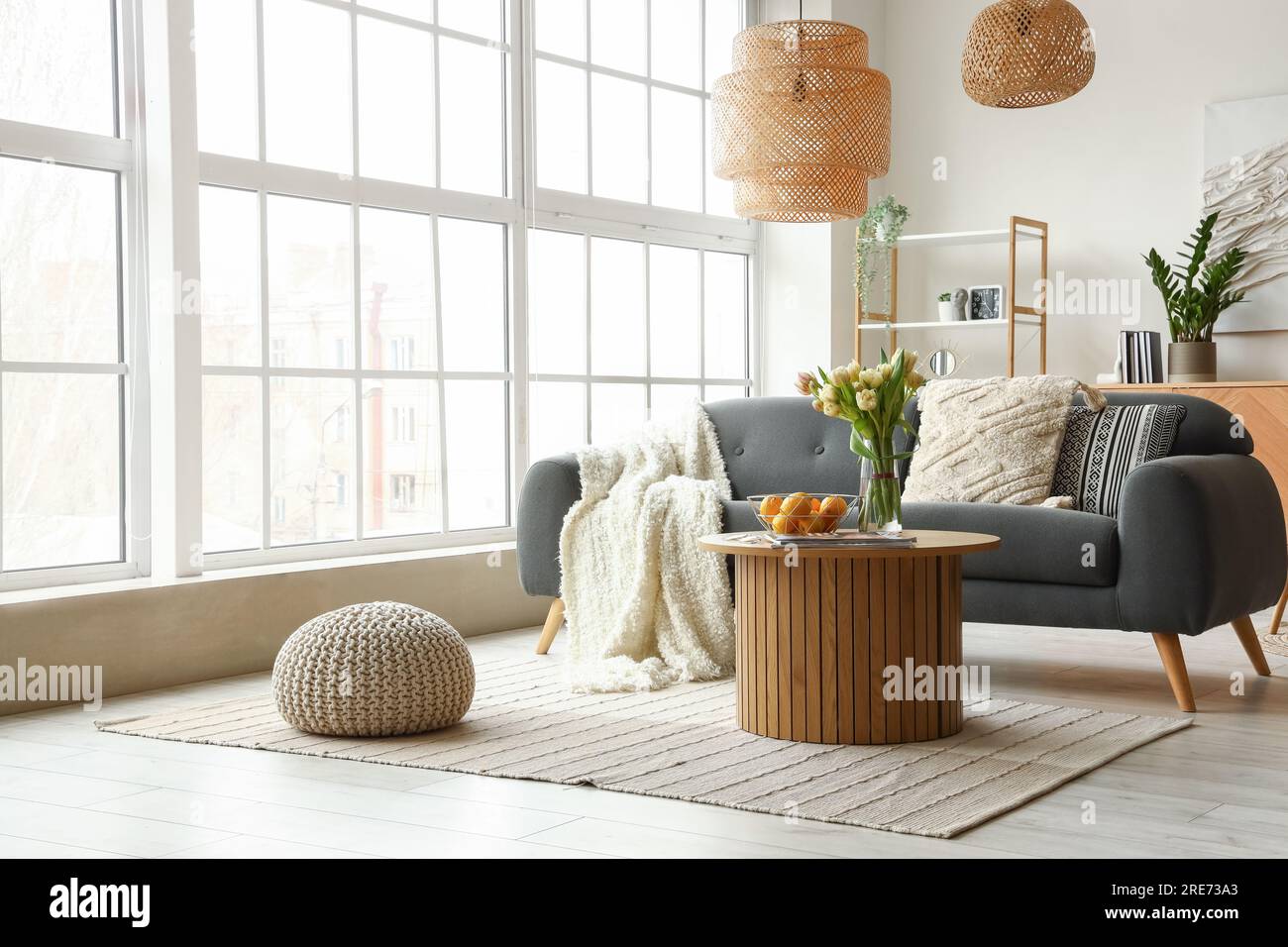 Interior of stylish living room with cozy sofa and coffee table near ...