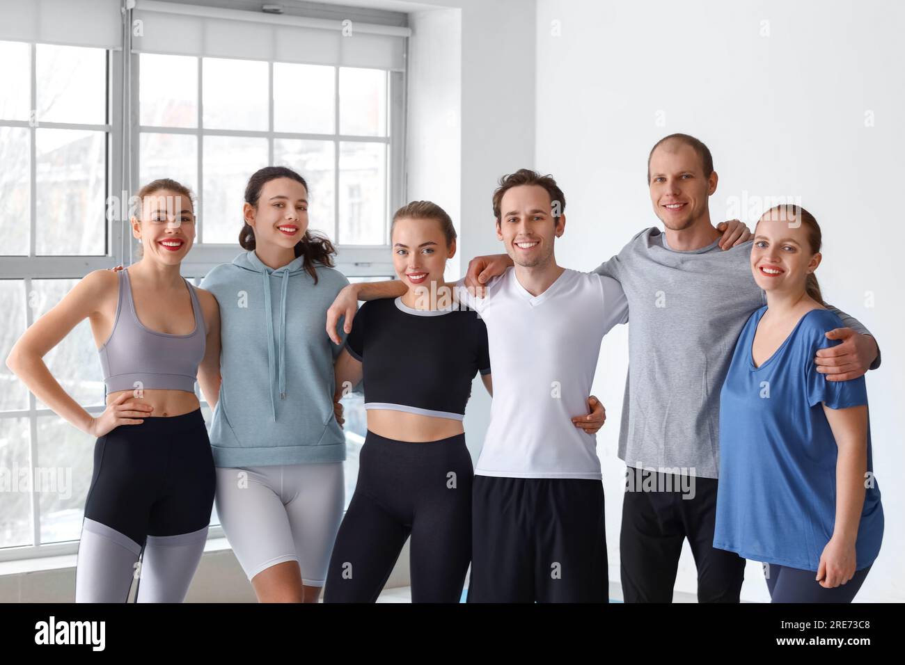 Group of sporty young people in gym Stock Photo - Alamy