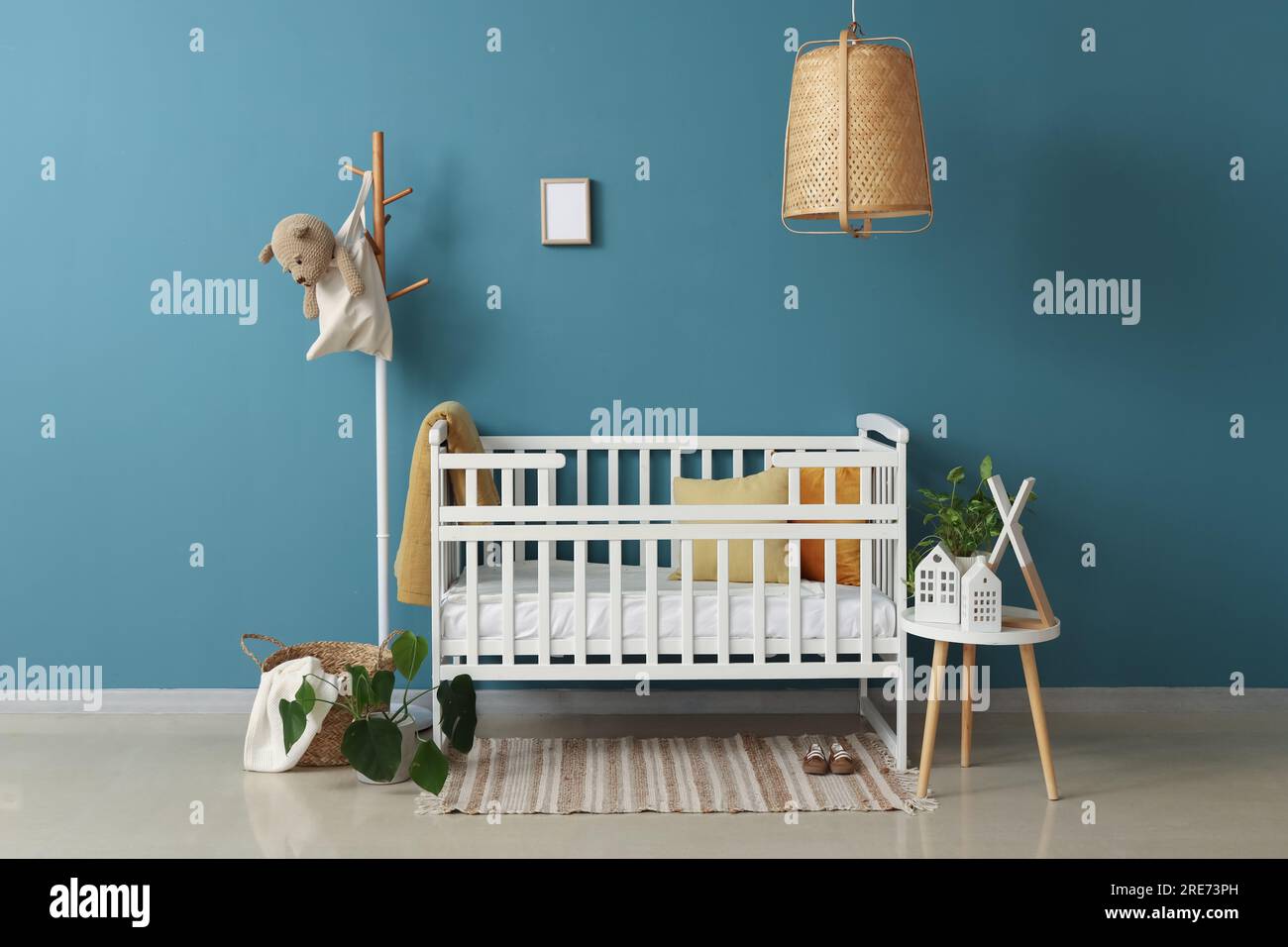 Interior of bedroom with baby crib, rack and table Stock Photo - Alamy
