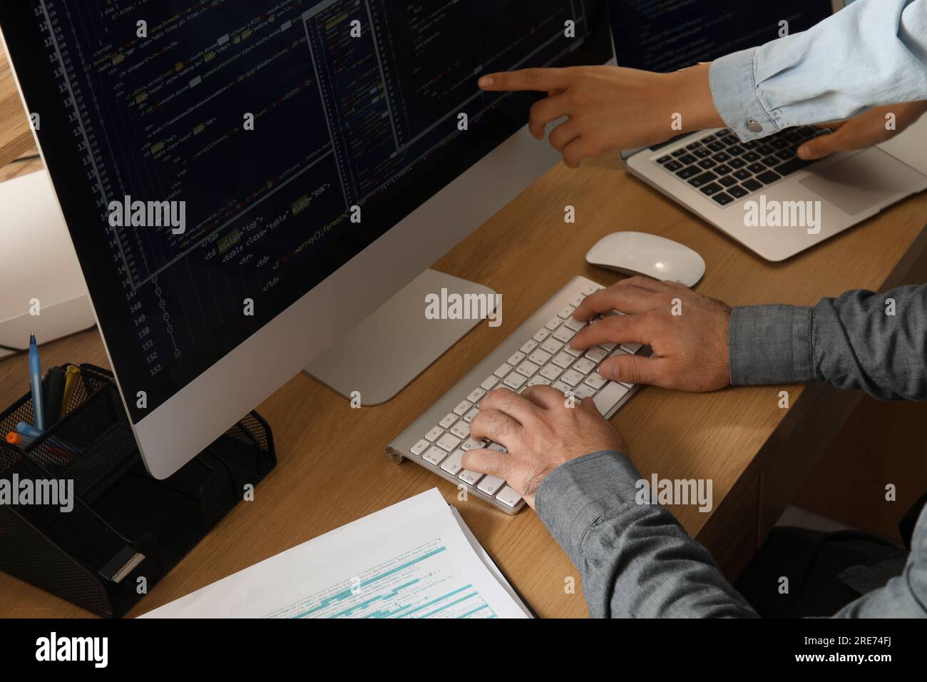 Male programmers working at table in office, closeup Stock Photo
