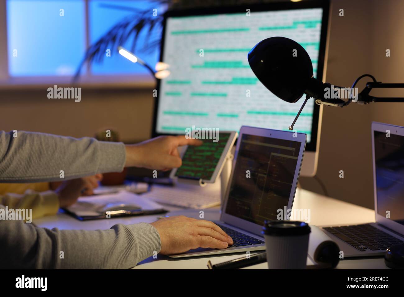 Programmers working in office at night, closeup Stock Photo