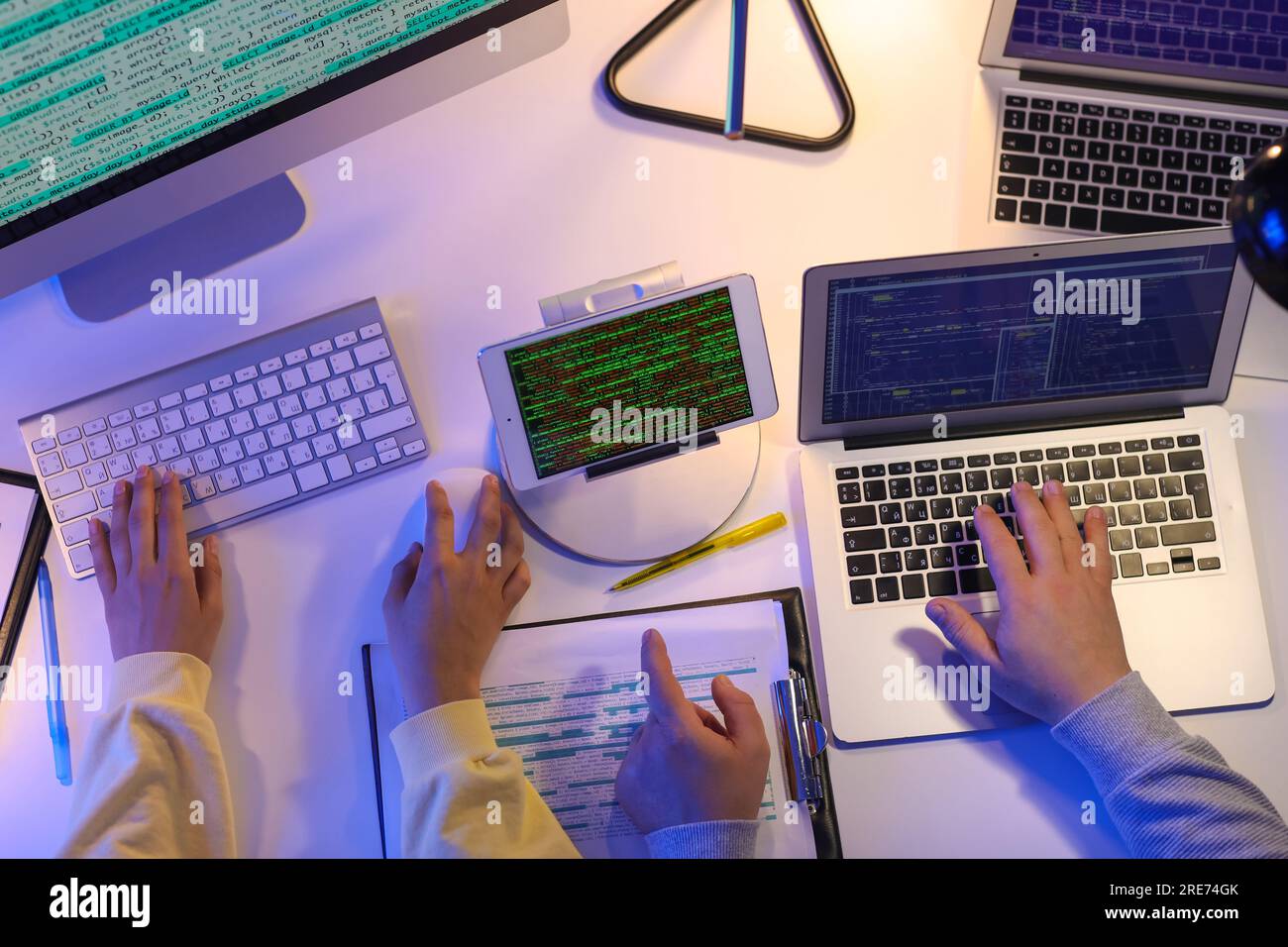 Programmers working in office at night, top view Stock Photo