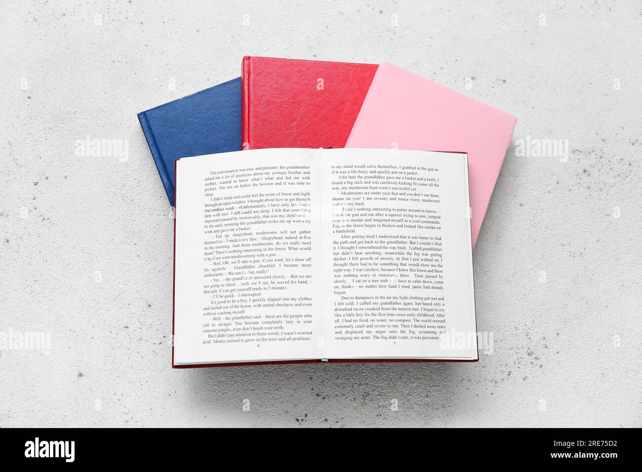 Open and closed books on white table Stock Photo - Alamy