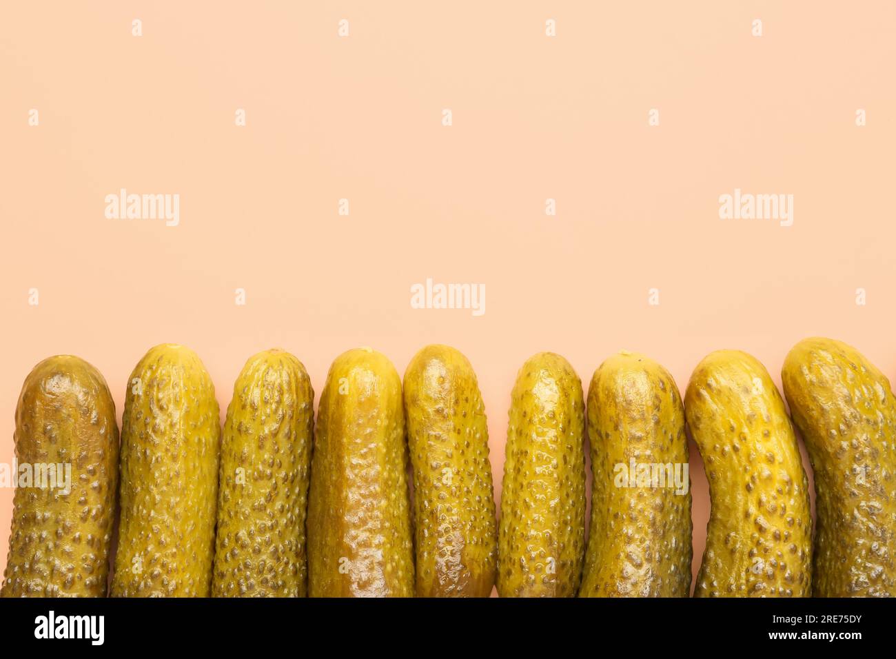 Pickled cucumbers on orange background Stock Photo