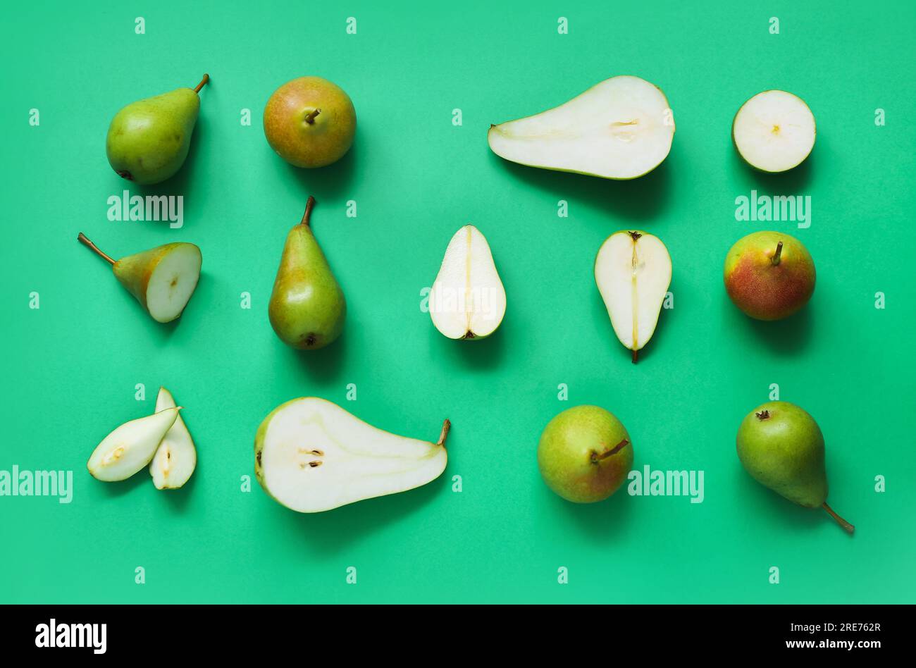 Different types of ripe pears on green background Stock Photo Alamy