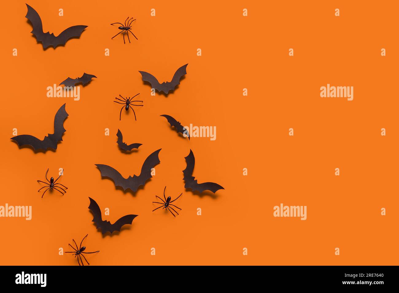 Paper bats and spiders for Halloween party on orange background Stock ...