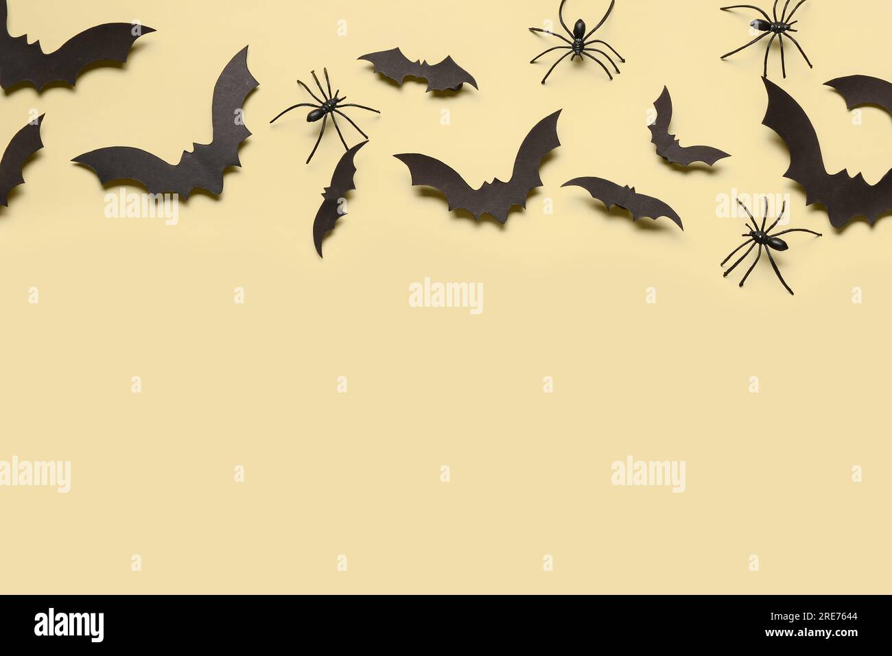 Paper bats and spiders for Halloween party on yellow background Stock ...