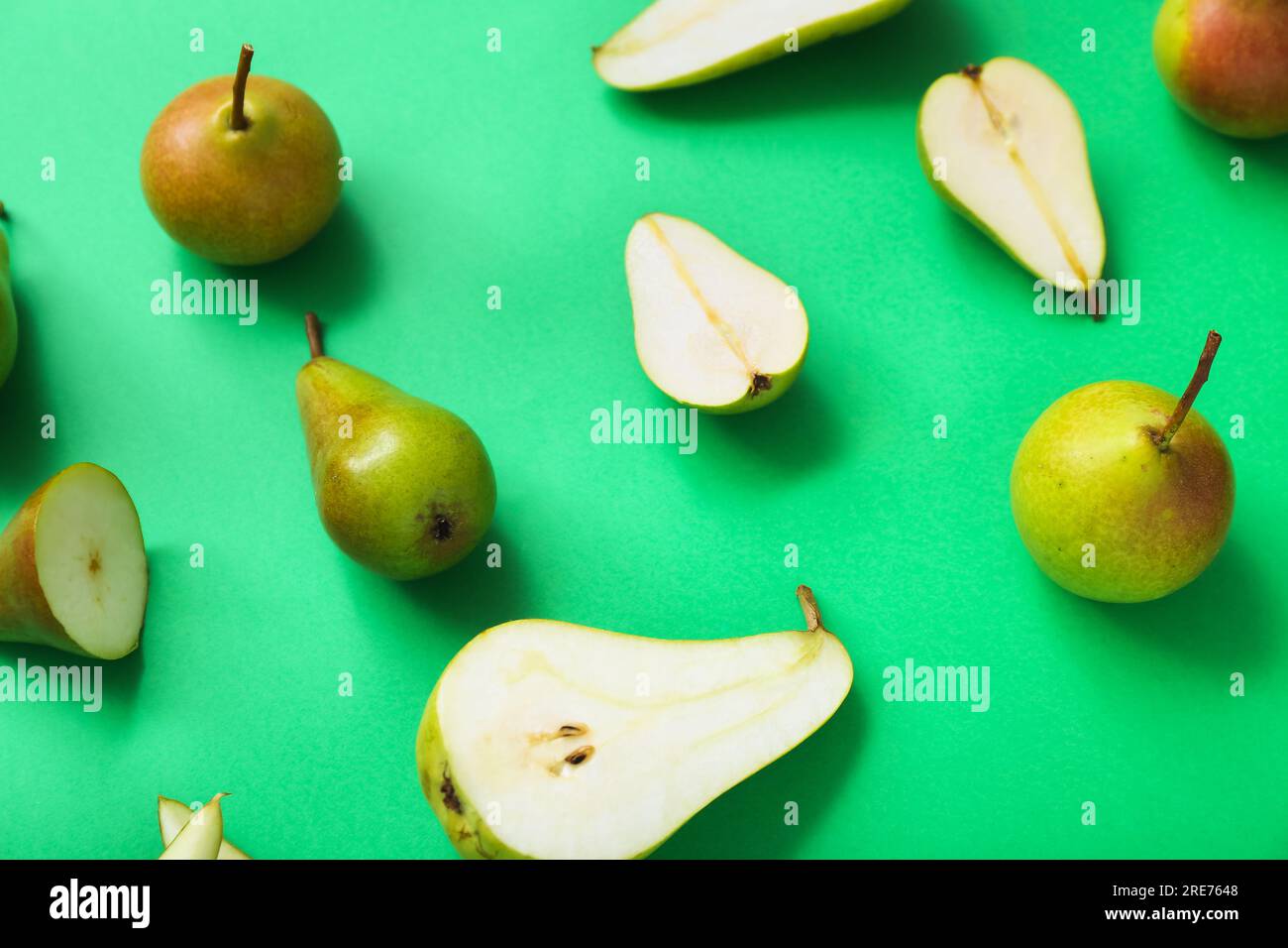 Different types of ripe pears on green background Stock Photo - Alamy