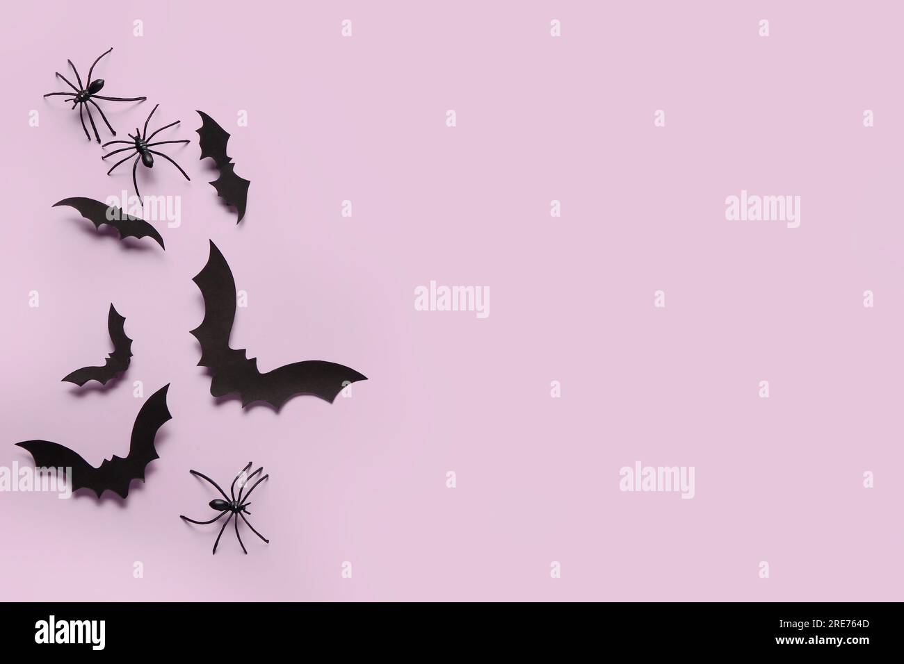 Paper bats and spiders for Halloween party on lilac background Stock ...