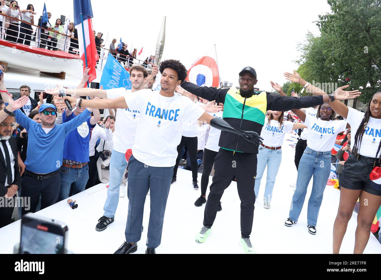 Guests and Usain Bolt poses with the Paris 2024 Olympic and Paralympic