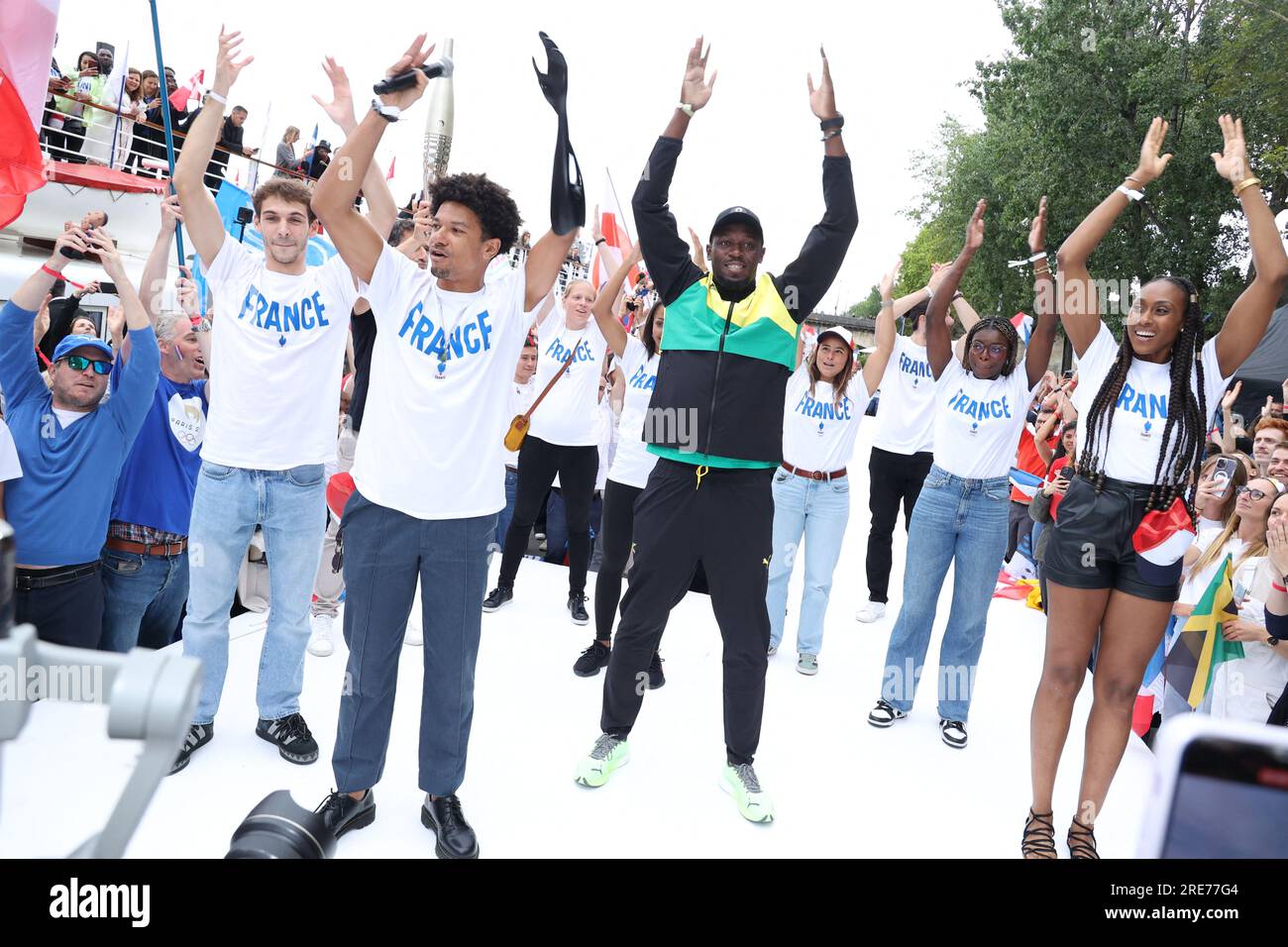 Guests and Usain Bolt poses with the Paris 2024 Olympic and Paralympic