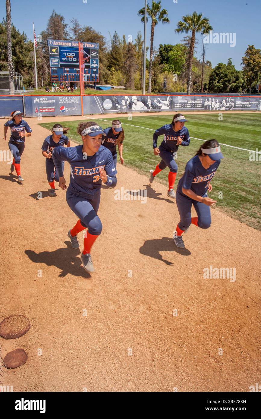 April 16, 2016: Multiracial college women's softball players sprint as they prepare for a game on the field in Fullerton, CA. (Credit Image: © Spencer Grant/ZUMA Press Wire) EDITORIAL USAGE ONLY! Not for Commercial USAGE! Stock Photo