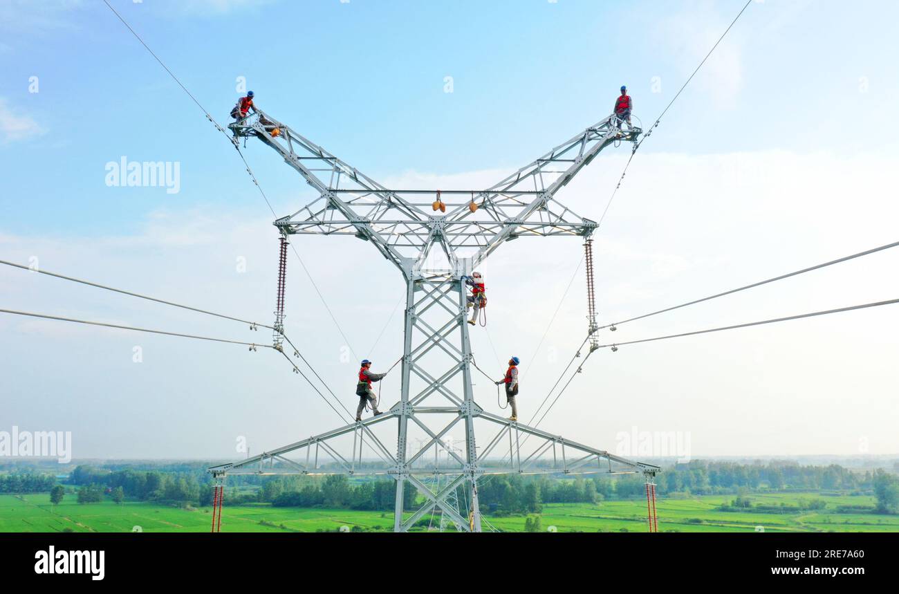 CHUZHOU, CHINA JULY 24, 2023 Electricity workers brave high