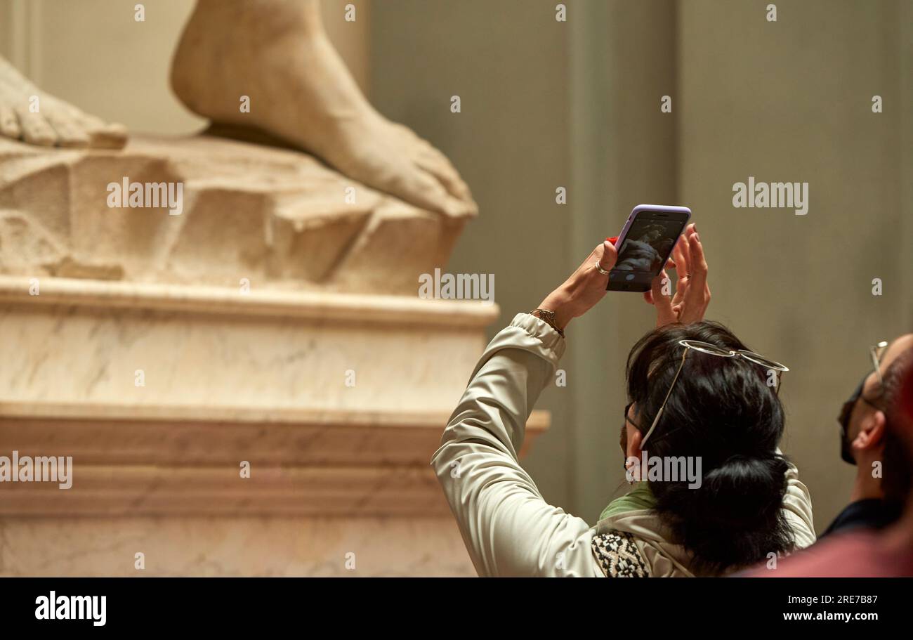 Tourists near the famous David statue in Accademia Gallery in Florence Stock Photo