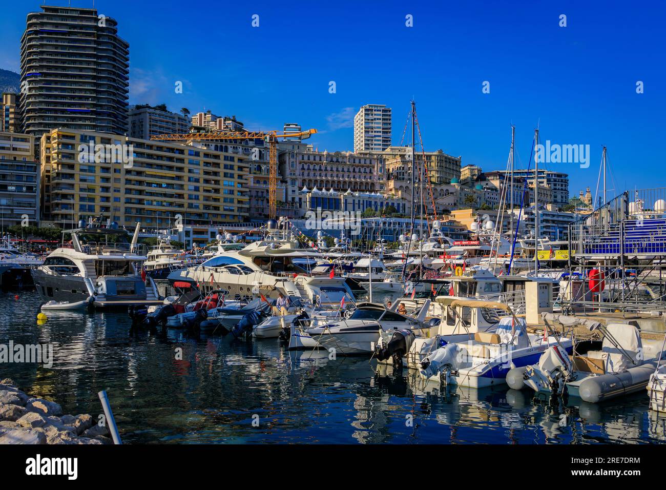 Monte Carlo, Monaco - May 24, 2023: Luxury yachts and empty grand stands tribunes in Yacht Club marina harbor for the Monaco Grand Prix F1 race Stock Photo