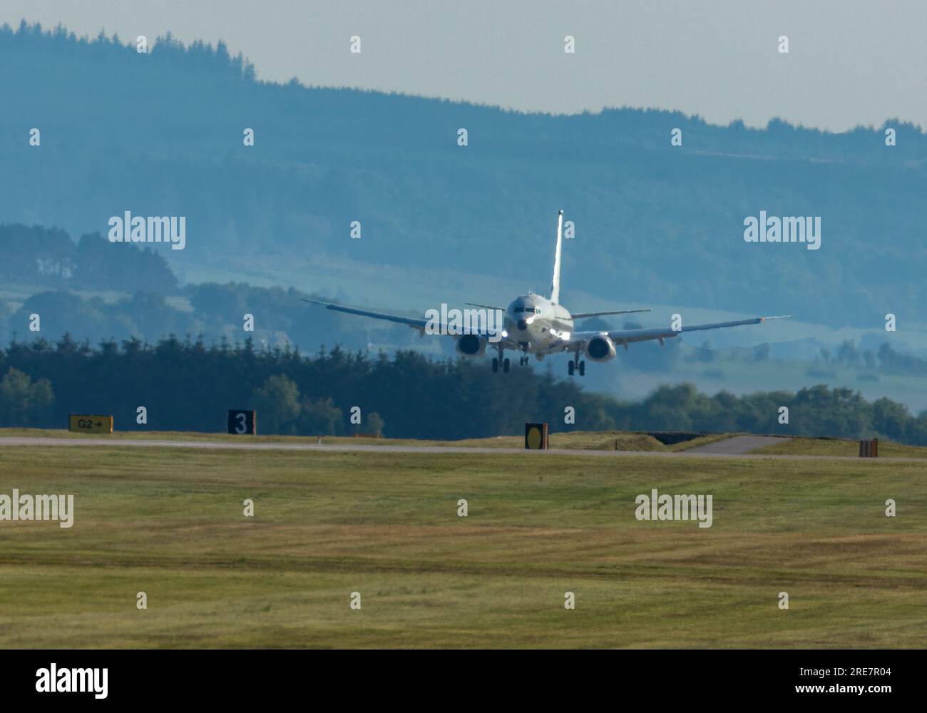 Boeing P-8 Poseidon, an American maritime patrol and reconnaissance aircraft coming in to land and take off on the runway at RAF Lossiemouth Stock Photo