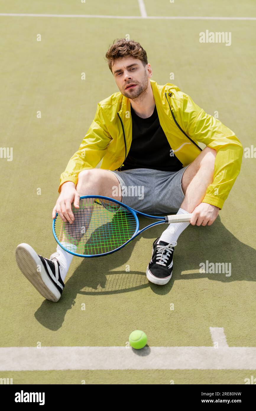 Professional tennis player wearing sports clothes holding racket and tennis  ball stock photo