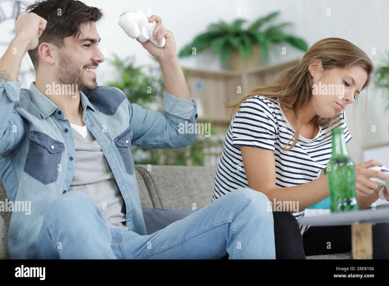 lady sulking because her boyfriend won the video game Stock Photo