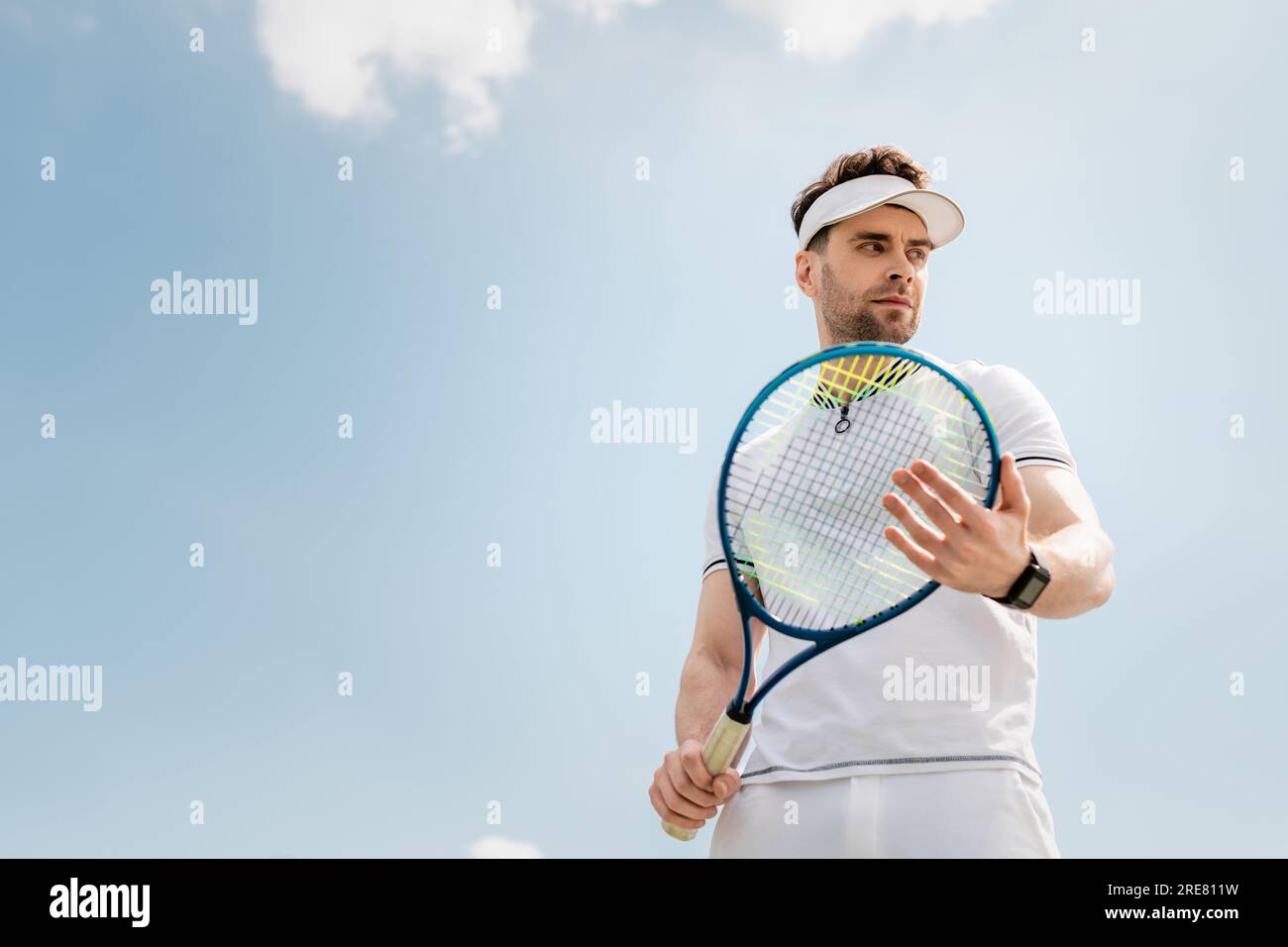 Man Using Tennis Racket healthy lifestyle, handsome man in active wear and visor cap holding ...
