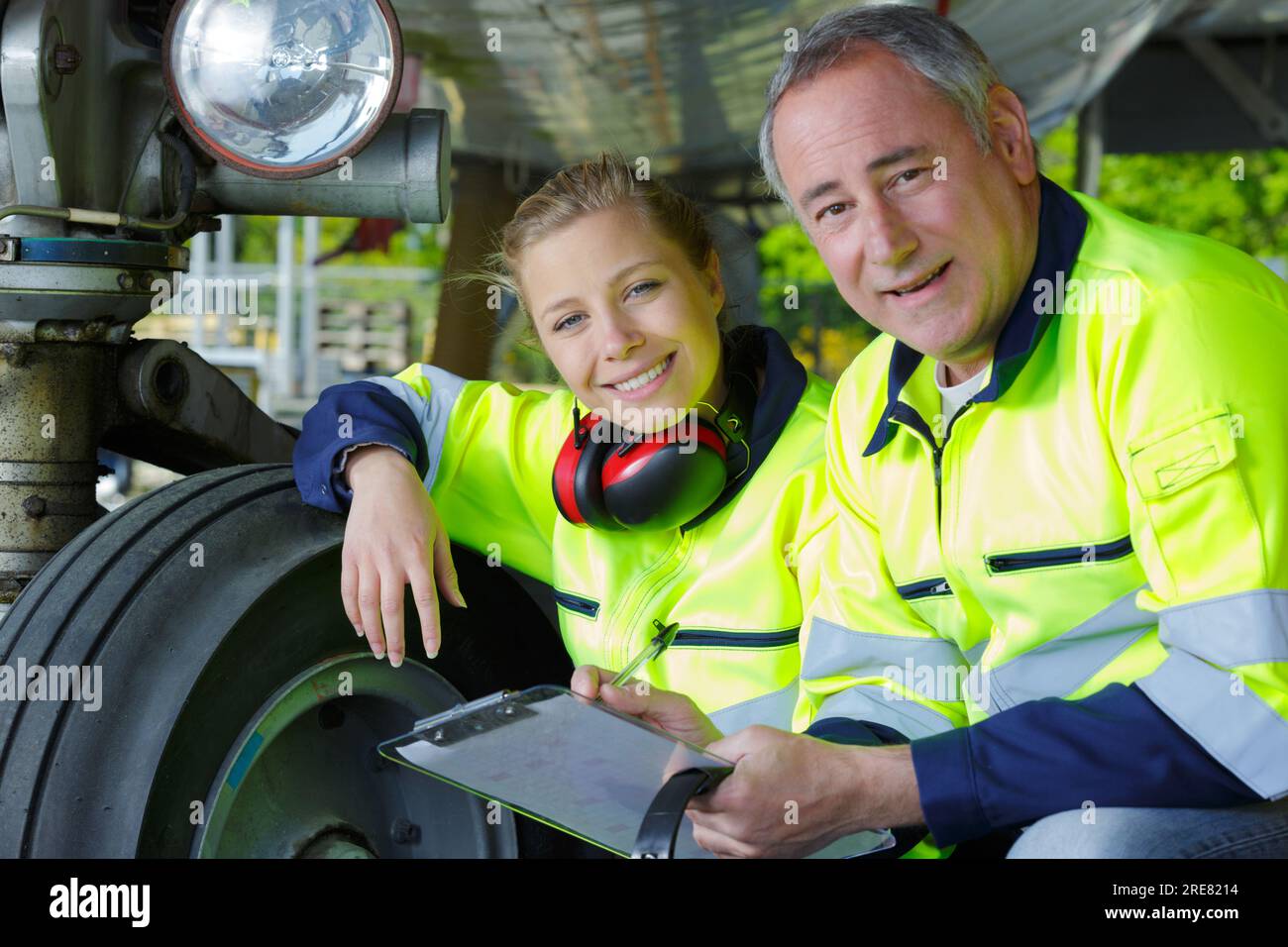 male and female aviation mechanics checking aircraft landing gear Stock Photo Alamy