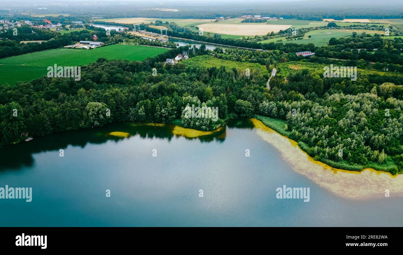 Aerial drone view of lake among forest, Nordrhein westfalen, Germany in summer day. Stock Photo