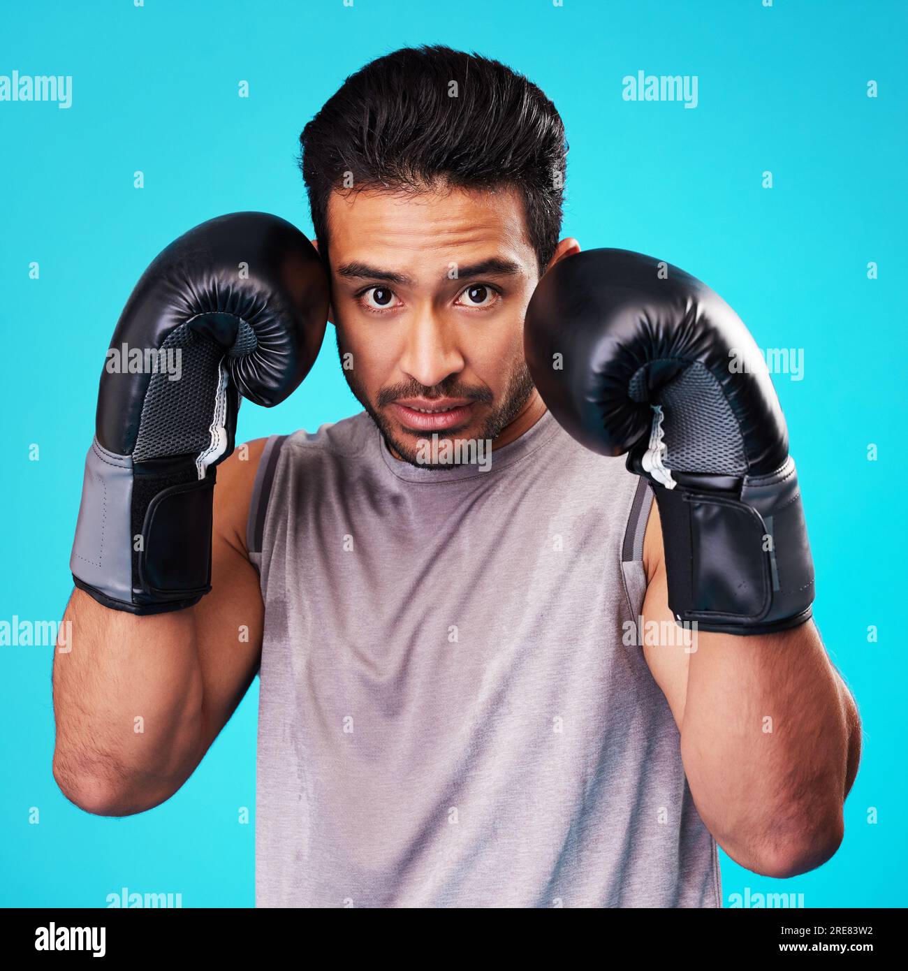 Boxing, man and fighter training, portrait or challenge against a blue