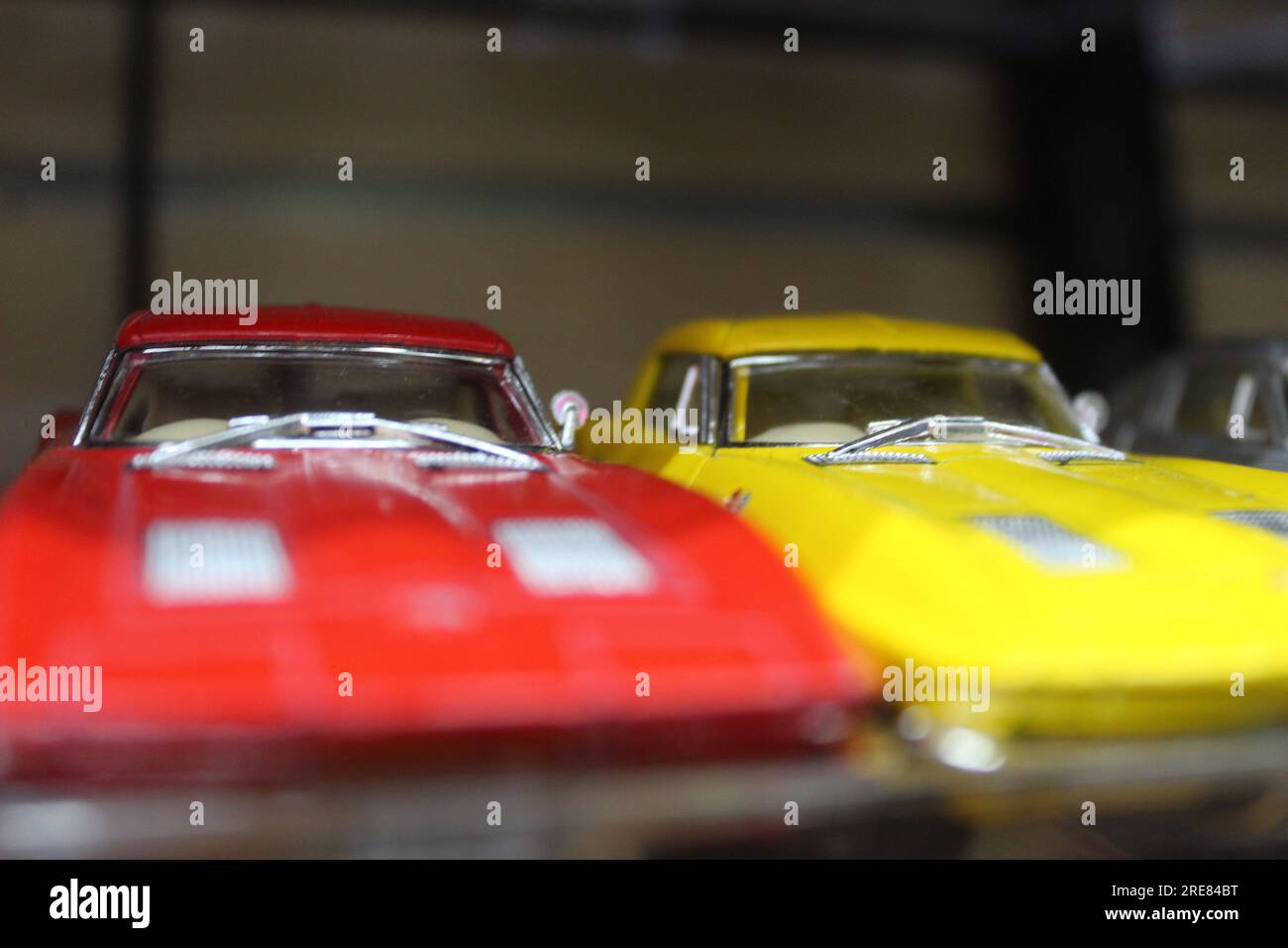 A close up photo of a small painted toy cars on a store shelf. Stock Photo