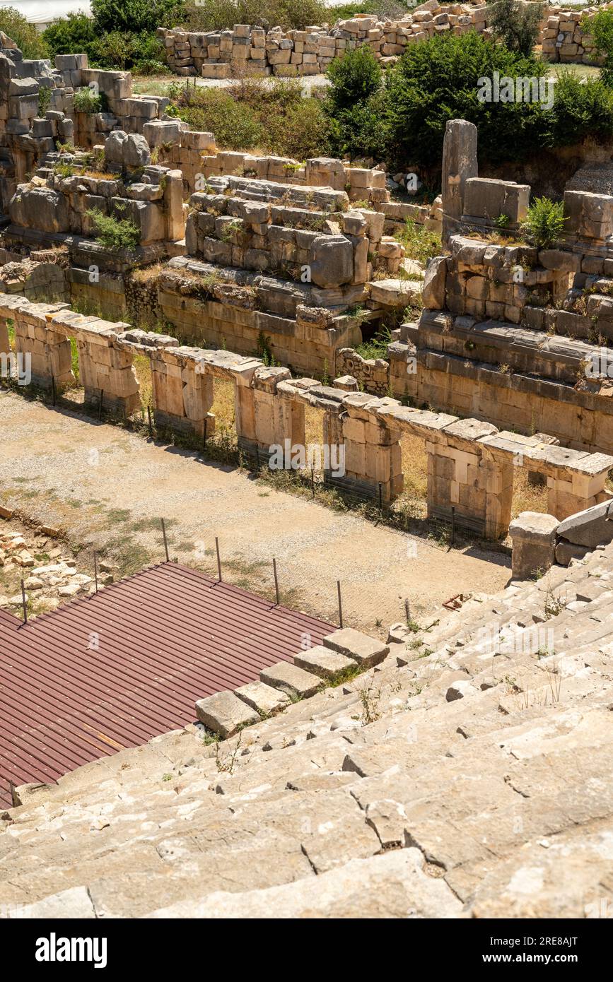 The ruins of the amphitheater and ancient rock tombs in the ancient city of Myra in Demre, Turkey Stock Photo