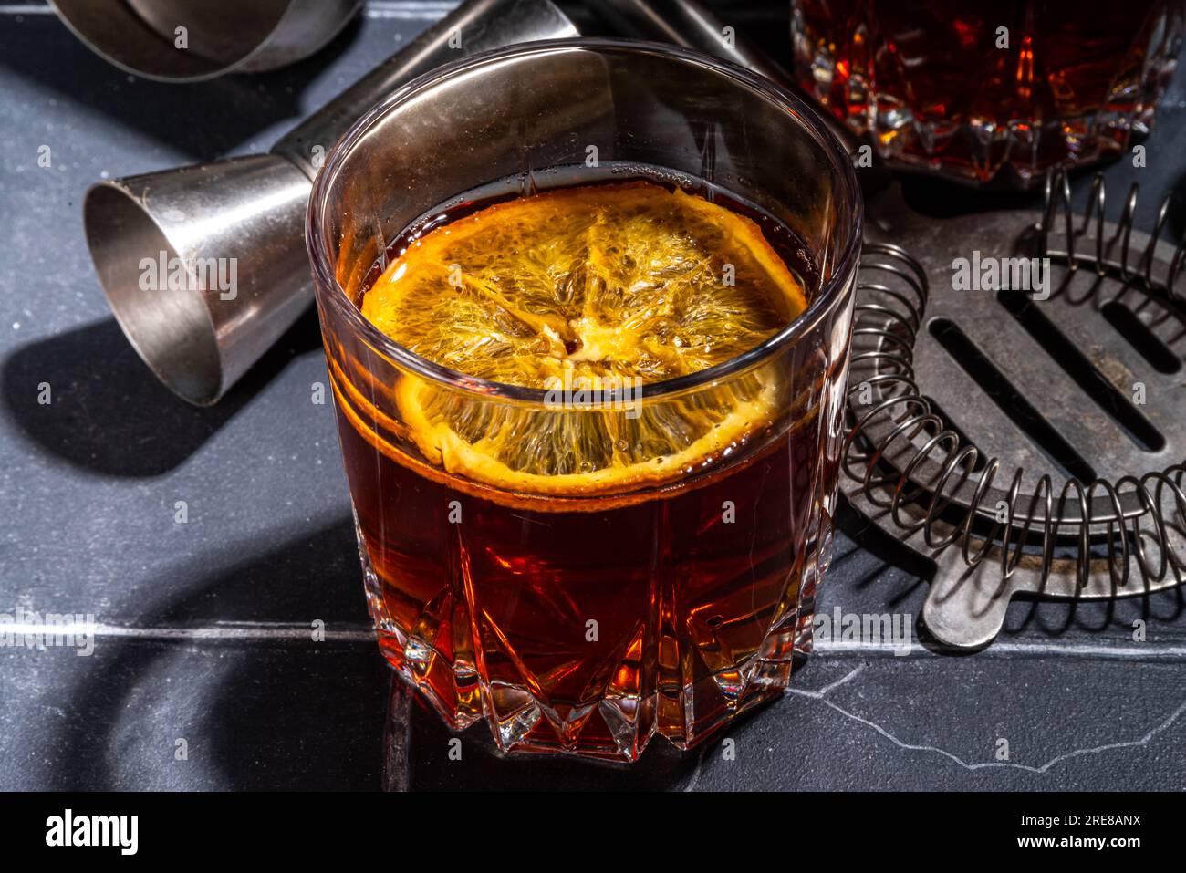 Hard alcohol drink with orange slice garnish. Negroni cocktail with ...