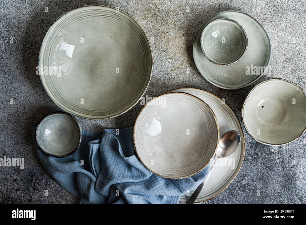 Table setting with ceramic bowls on grey concrete table Stock Photo