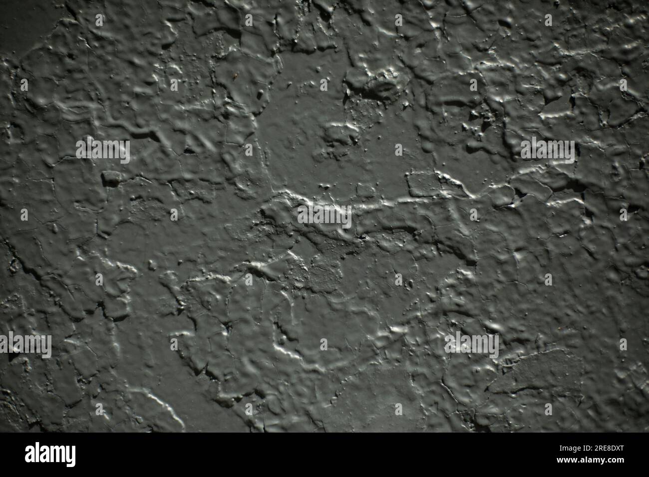 Gray paint on wall. Grey background. Paint on top of paint. Uneven