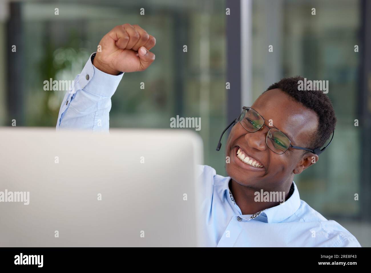 Winner, computer and call center with a black man cheering as a 