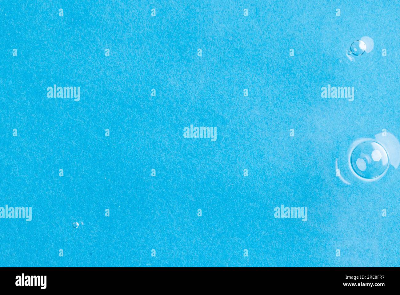 Close up of water ripples and waves with copy space on blue background ...