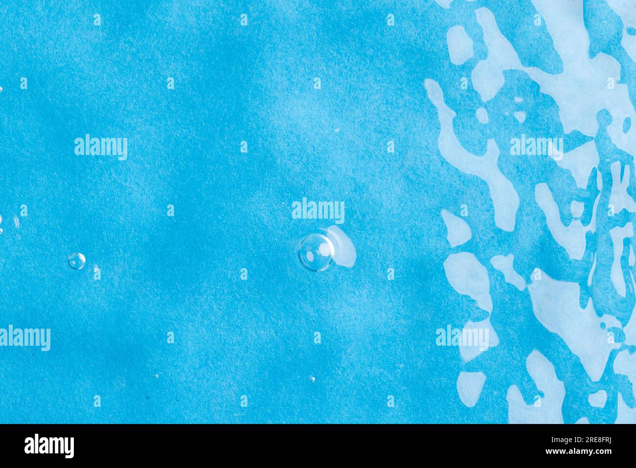 Close up of water ripples and waves with copy space on blue background ...