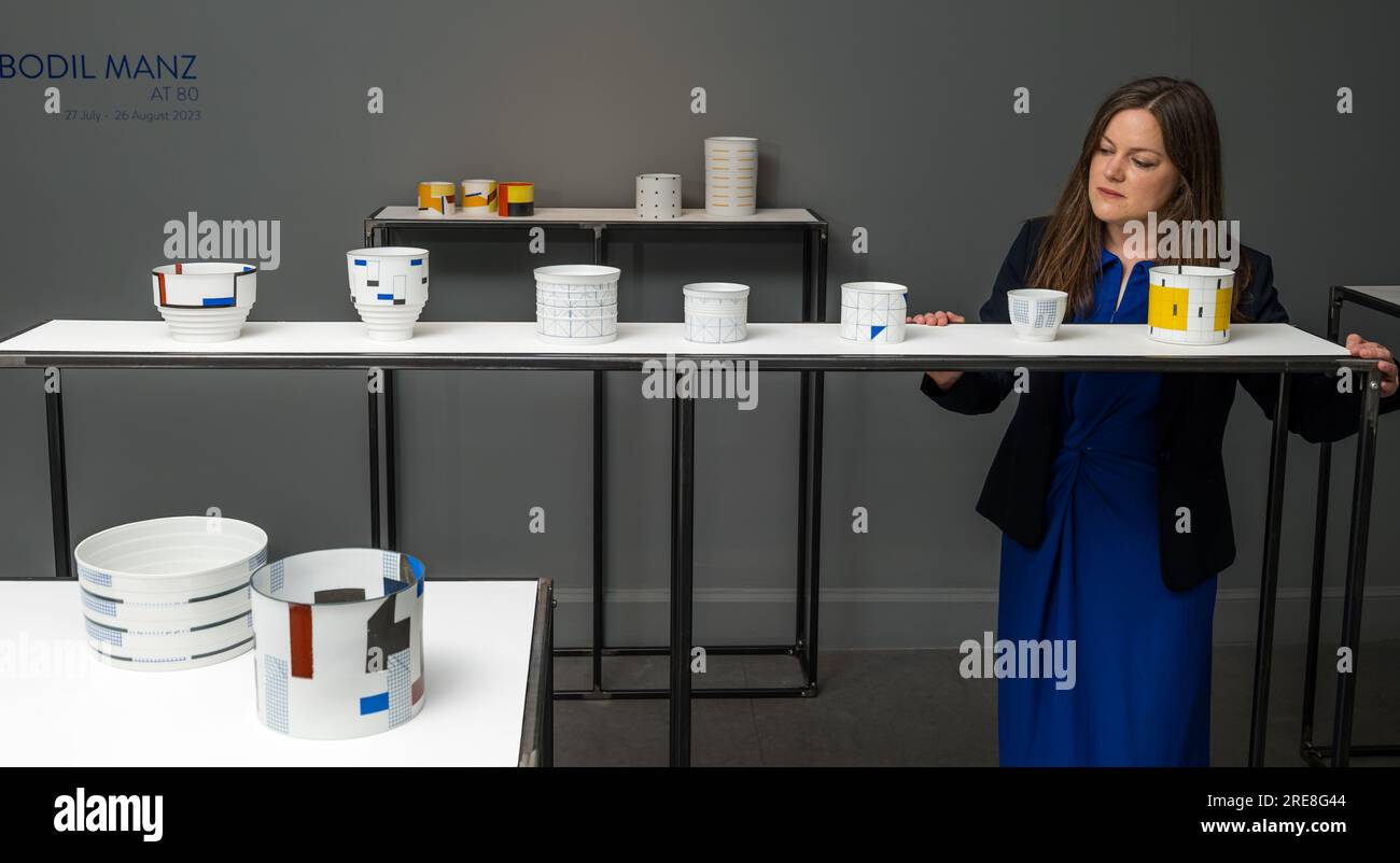 The Scottish Gallery, Edinburgh, Scotland, UK, 26 July 2023, Edinburgh Art Festival: a new exhibition called Wonder Women features ceramic works from internationally acclaimed ceramcist Bodil Manz as part of the Edinburgh Art Festival. Pictured: a member of the gallery staff with fine ceramics by Bodil Manz. Credit: Sally Anderson/Alamy Live News Stock Photo