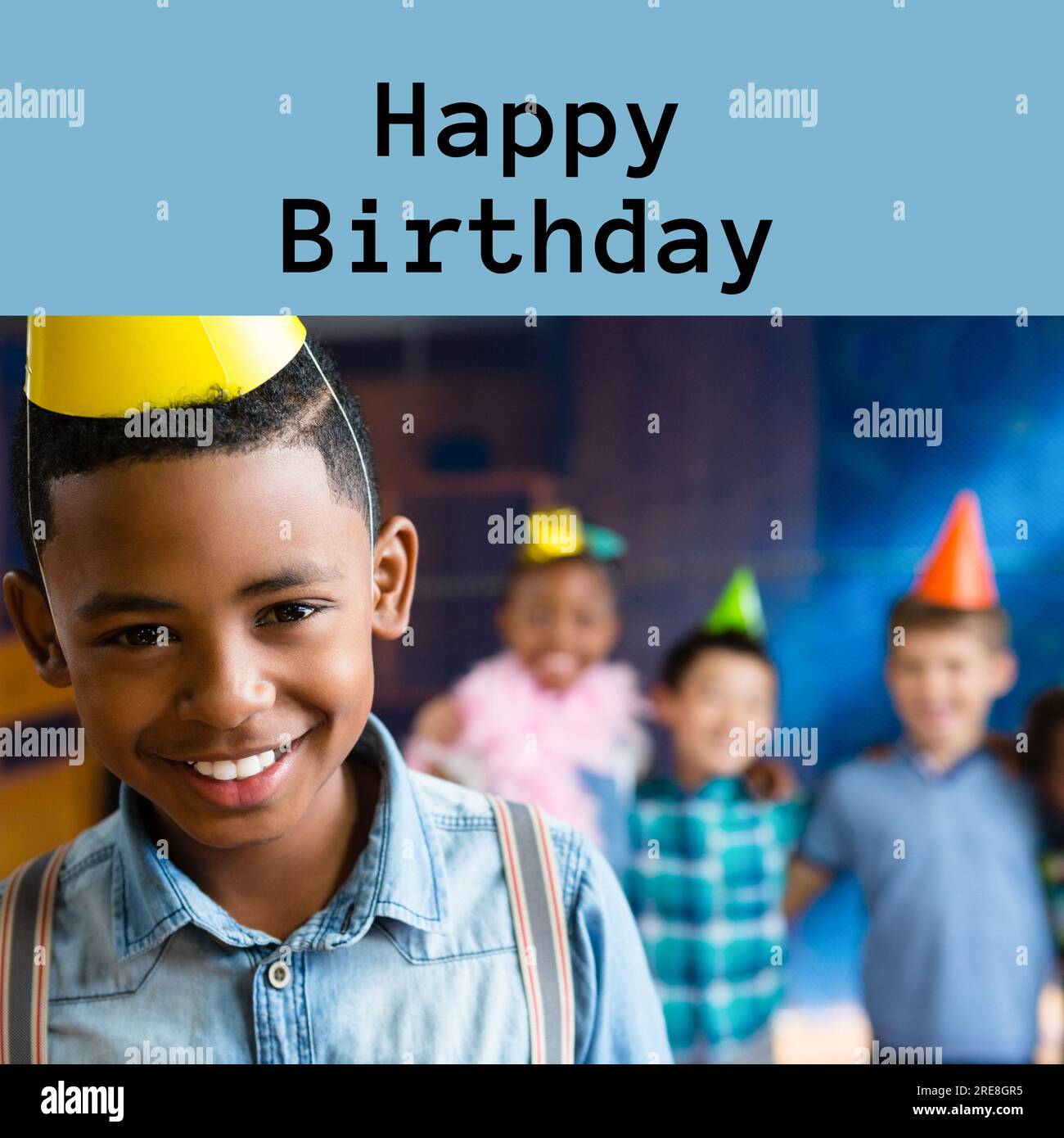 Composite of happy birthday text over happy african amercian boy in party hat at birthday party Stock Photo