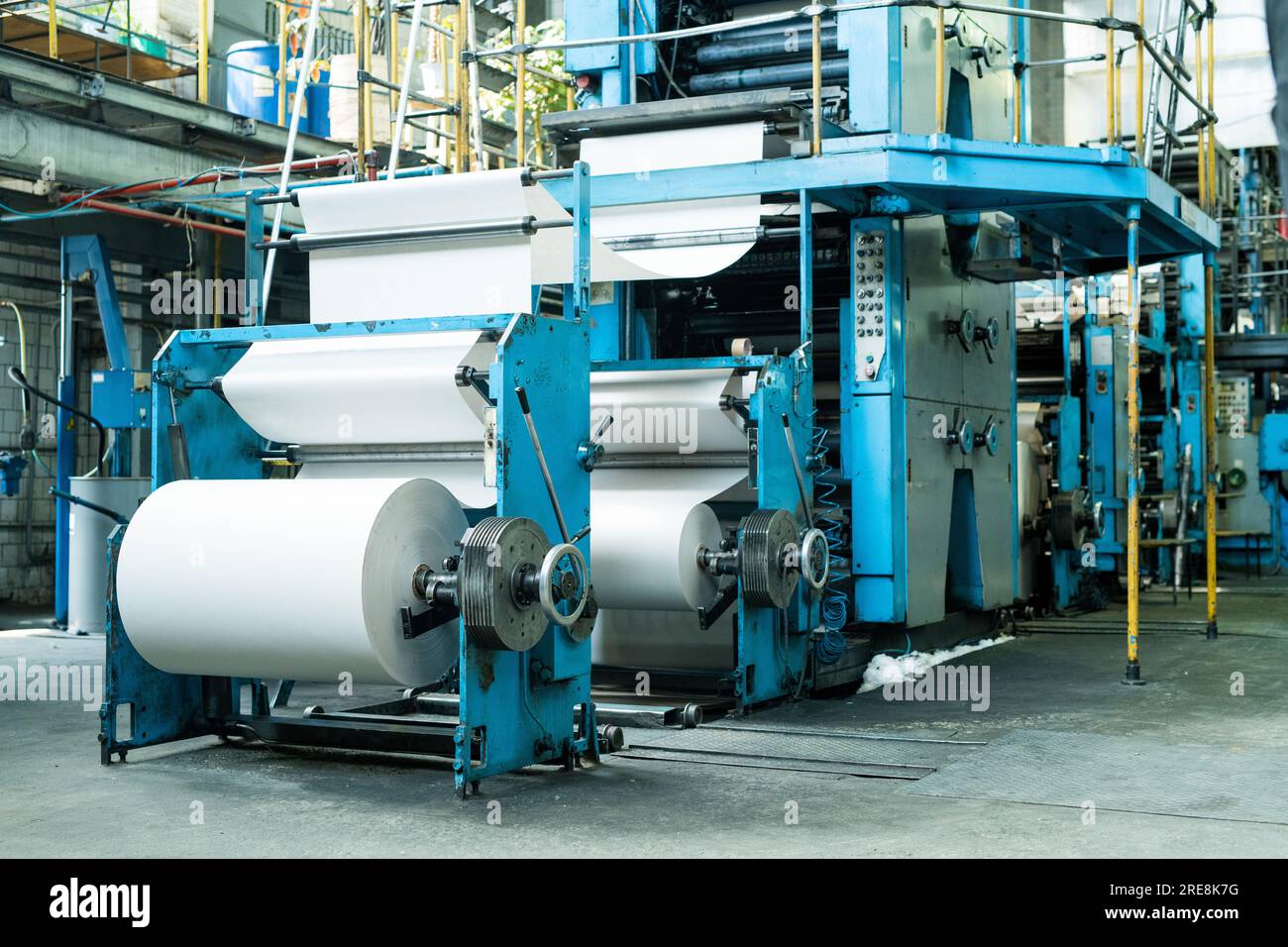 Large printing press with paper roll printing newspaper on production