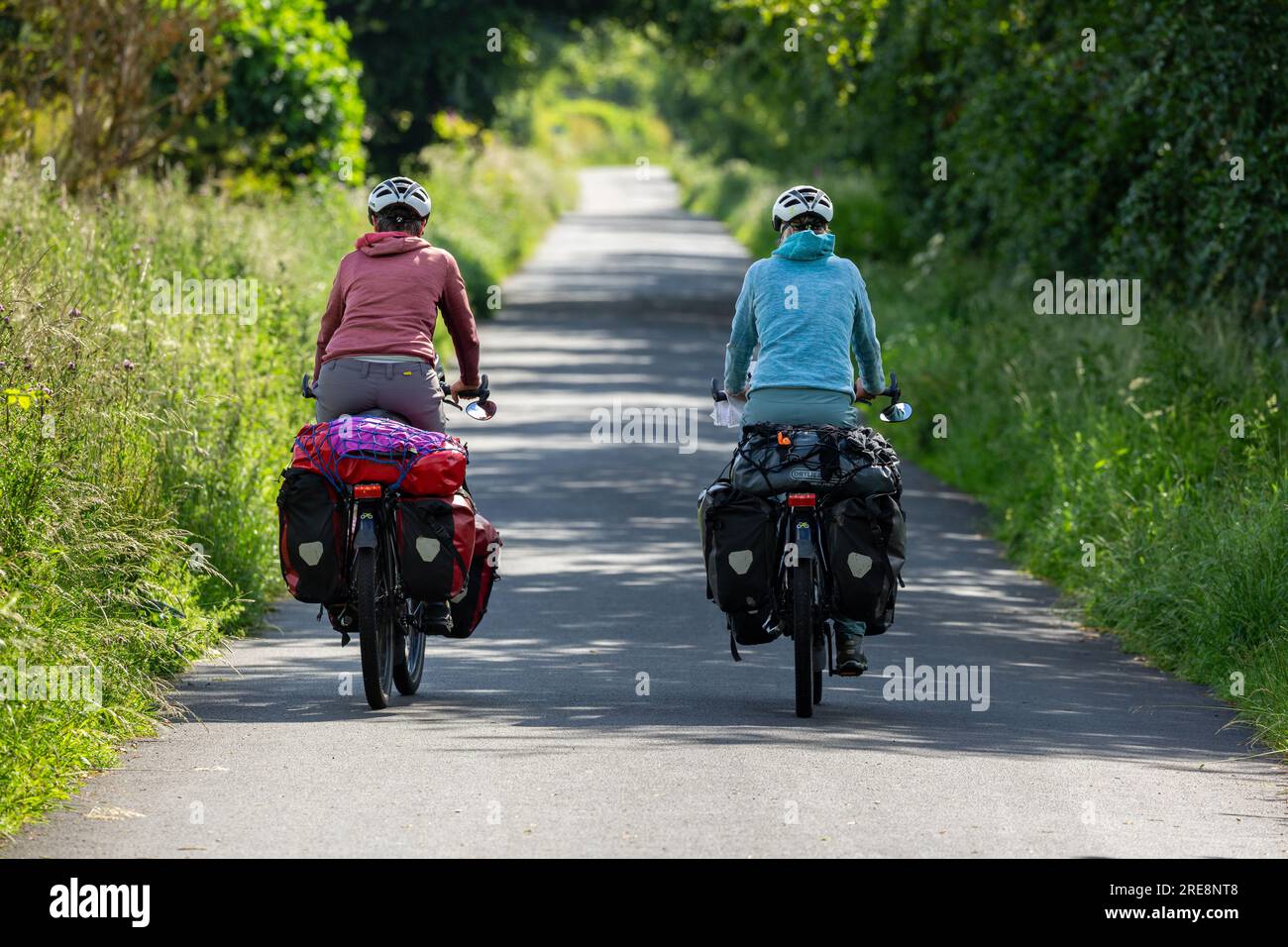 Two senior women cycle touring with full panniers Stock Photo Alamy